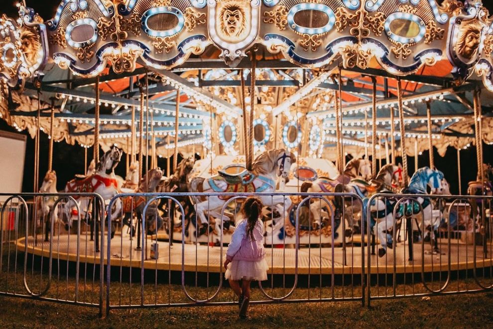 Child standing in front of a Carousel