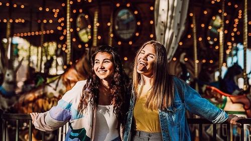 two girls at the carousel