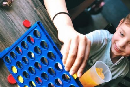 child playing Connect Four