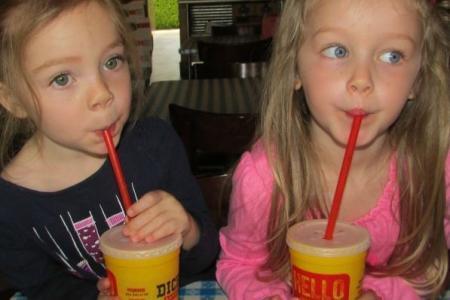 children drinking soda from a straw